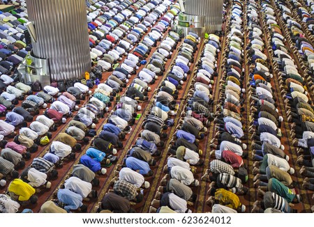 Muslim Praying Together in Istiqlal Mosque, the biggest mosque in South East Asia, located in Jakarta, Indonesia. Royalty-Free Stock Photo #623624012