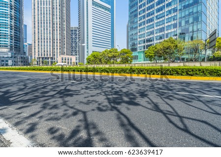 cityscape and skyline of shanghai from empty asphalt road