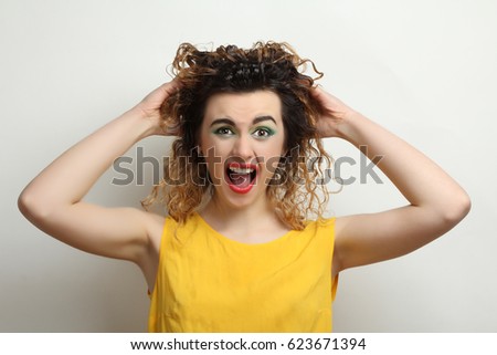 Evil screaming woman on a neutral background