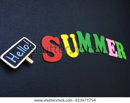 Concept hello summer background. summer wooden letters on black chalkboard. concept summer background. 