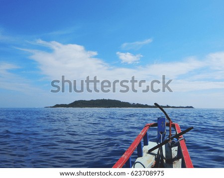 An inspirational photo that represents island hopping using a traditional boat as a means of transport. This photo was taken between the islands of Bali and Lombok in Indonesia       