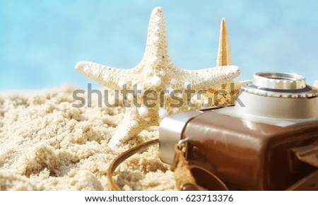 Star fish with old camera in wet sand, Travel concept, Vacation time
