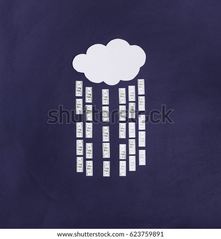 Money rain coming from the cloud on a blue background. Everything is made of paper.