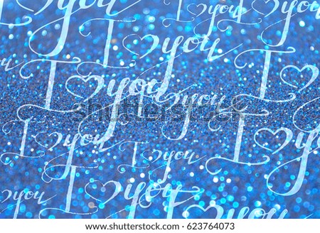 Background with hand written scratched words I Love You on blue glitter in vintage style