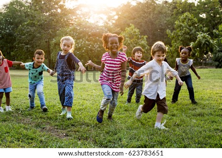 Group of Diverse Kids Playing at the Field Together Royalty-Free Stock Photo #623783651