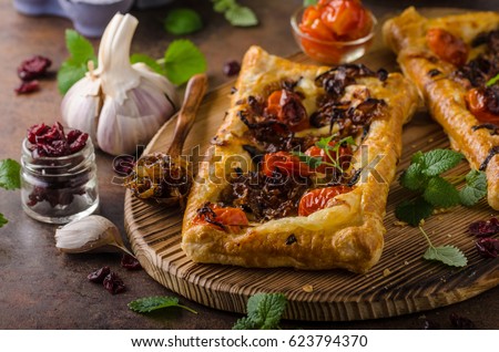 Puff pastry vegetarian pizza with caramelized onion, herbs garlic and tomatoes