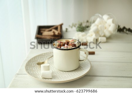Composition with tasty cocoa and marshmallow on wooden table