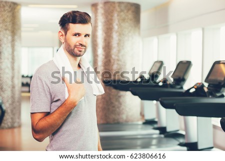 Smiling young man portrait in gym
