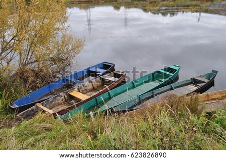 Colorful fisherman boats on the river in the autumn, Russia, Krasnovishersk