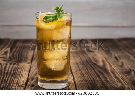 iced tea with lemon and fresh mint on wooden background Royalty-Free Stock Photo #623832395