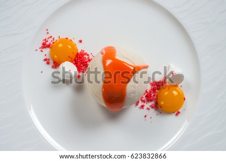 ice cream beautifully decorated on a white plate with quail eggs