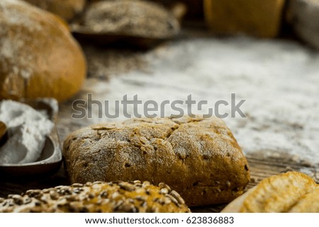 Assortment of baked bread on wooden rustic table background