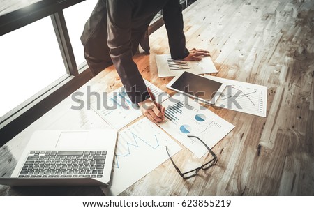 woman investment consultant analyzing company annual financial report balance sheet statement working with documents graphs. Stock market, office, tax, education concept. Hands with charts papers Royalty-Free Stock Photo #623855219