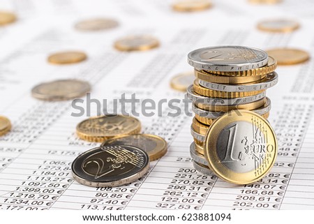finance business accounting stock background with stack of euro coins on data sheet