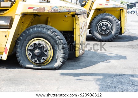 flat tire of heavy equipment container handler forklift  Royalty-Free Stock Photo #623906312