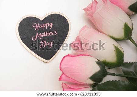Happy Mother's Day tag with flowers shot from top over white wooden background