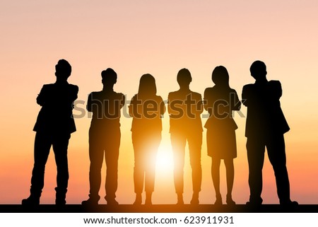 Silhouette of Business People Celebration Success Happiness Team standing with arms crossed at Sunset Evening Sky Background