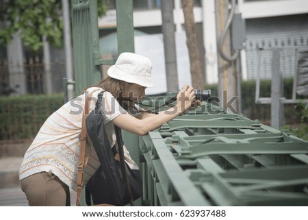 Women photographing. Take a photo on the bridge