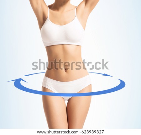 Close-up of thin and beautiful female body. Weight loss, sports, exercising, water balance, healthy nutrition concept. Cyan arrows.