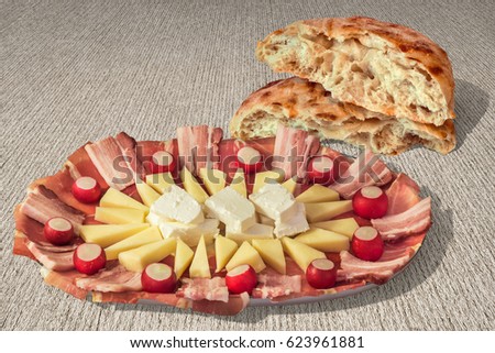 Plateful Of Traditional Gourmet Welcome Appetizer Savory Dish Meze With Fireplace Baked Aromatic Leavened Pitta Flatbread Torn Loaf Set On Coarse Grain Striped Brown Kraft Paper Background 
