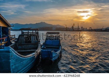 Wooden boat parked on the sea, the beautiful sunset in Fujian Province, China