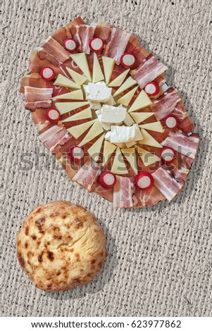 Plateful Of Traditional Gourmet Welcome Appetizer Savory Dish Meze With Fireplace Baked Aromatic Tender Leavened Pitta Flatbread Loaf Set On Coarse Grain Bleached Jute Canvas Grunge Surface