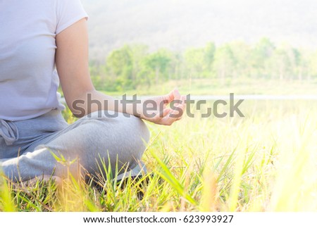 Young woman doing yoga in nature park.