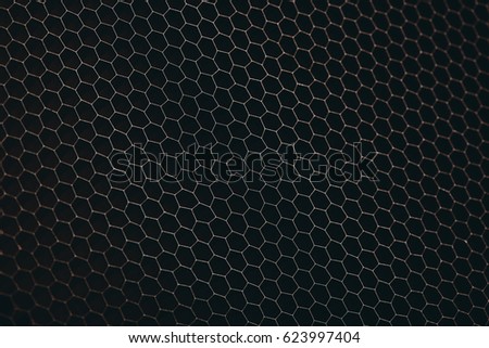 abstract texture honeycomb. Metallic net background or texture. metal mesh. full frame colorful illuminated detail of a metallic grid in front of a loudspeaker. Colorful abstract background.