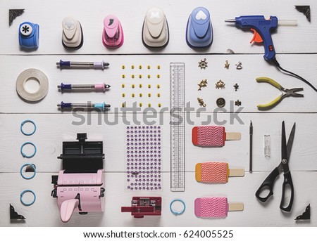 top view of the layout of tools for needlework and scrapbooking on wooden boards