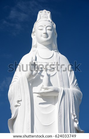 Majestic white Buddha statue on blue sky background. The Lady Buddha (the Bodhisattva of Mercy) at the Linh Ung Pagoda, Danang (Da Nang), Vietnam.