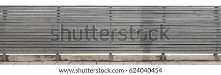 The rural long solid fence is made of horizontal wooden boards and painted with gray oil paint. Isolated panoramic collage from several outdoor photos