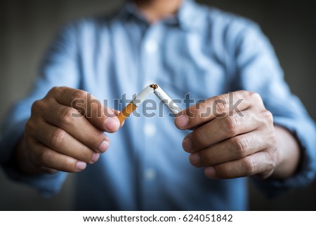 Male hand crushing cigarette.Quitting from addiction concept. Royalty-Free Stock Photo #624051842