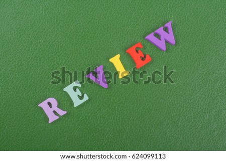 REVENUE word on green background composed from colorful abc alphabet block wooden letters, copy space for ad text. Learning english concept