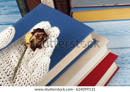 Open book, hardback books on wooden table, rose and white gloves knitted crochet Back to school. Copy space for text