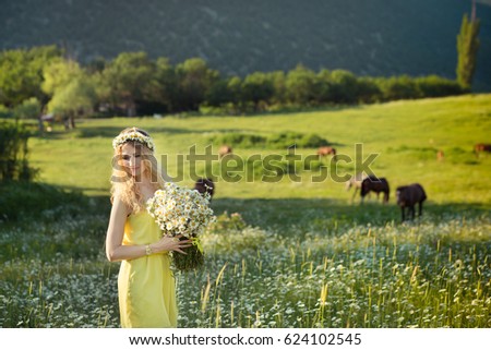 Beautiful lady with or without cute daughter on camomile field full of flowers