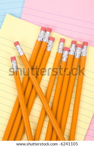 colorful notepaper and pencils close up shot