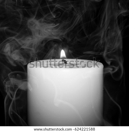 A black and white, close-up photograph of a burning candle with a smoke overlay. This photo was taken in Brisbane, Australia.