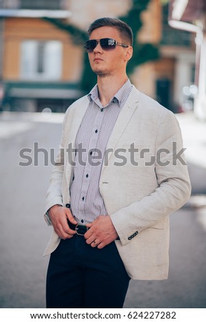 guy in the jacket wears glasses on the street, men's looks
