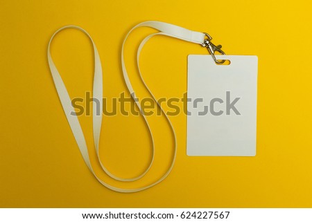 Blank identification card with white neckband isolated on yellow background, space for text.