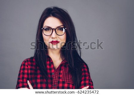 Educated serious Brunette girl in glasses smiling. Worker, manager, student people. Education concept