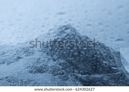 Abstract of Rain drop over the snow mountain background