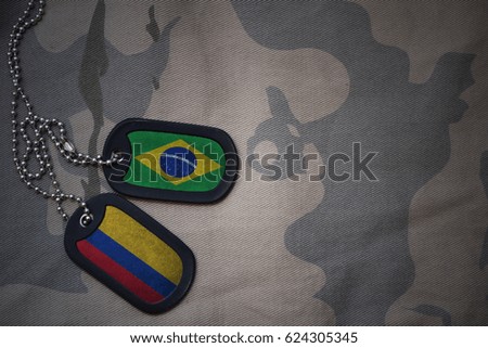 army blank, dog tag with flag of brazil and colombia on the khaki texture background. military concept