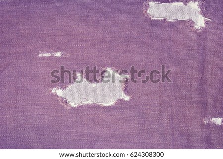 The texture of the lilac denim with holes