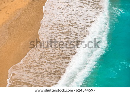 Sandy beach with turquoise sea wave