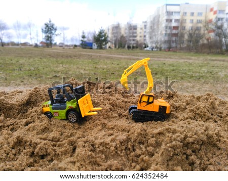 Excavator and loader Toy work at construction site