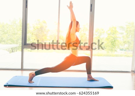 Blurred photo of young girl practicing yoga, Wellness concept. Calmness and relax, happiness. Peaceful Meditation in morning sunny day for good health.in soft light.