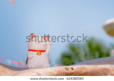 doll cat sat smiling on the background sky