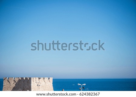 Skyline blue sea old tower light blue sky vignette minimal travel holiday old castle water background