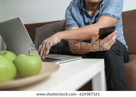 businessman working with smartphone and digital tablet computer on wooden desk in modern office 