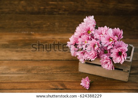 Summer flowers in wooden box. Space for text